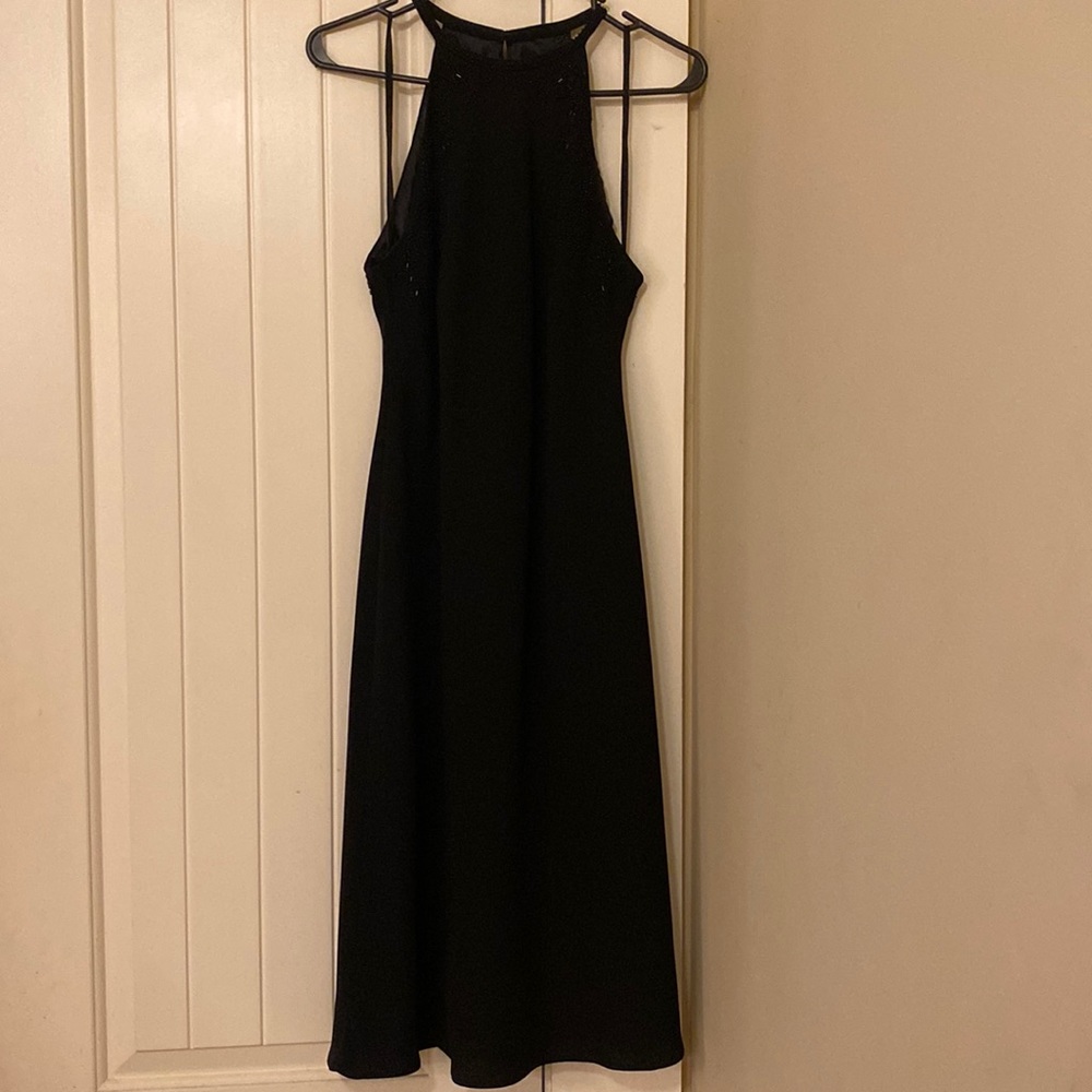 Black cocktail dress with beading around neck, knee-length, size 10